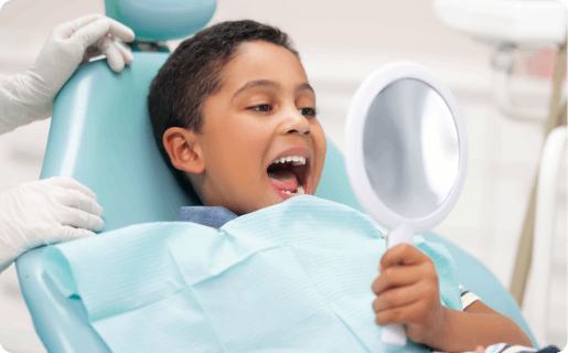 Young boy smiling in front of mirror