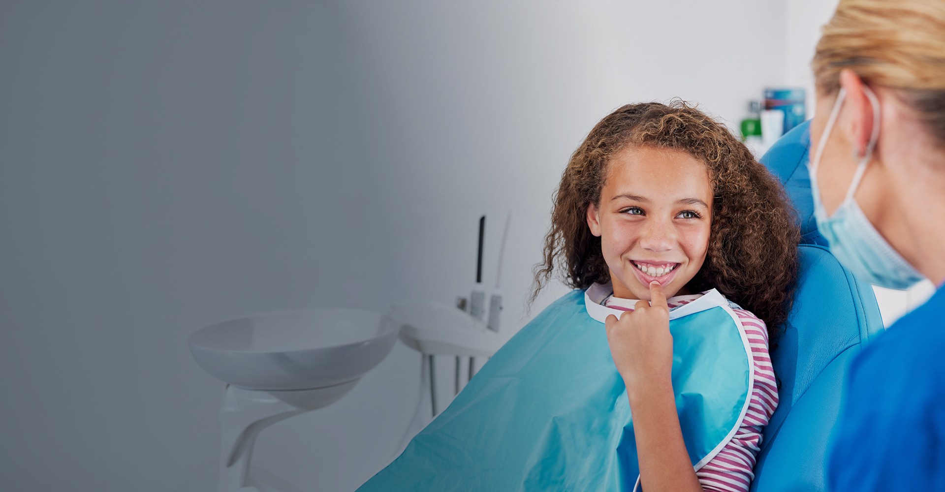 Young girl listening to dentist